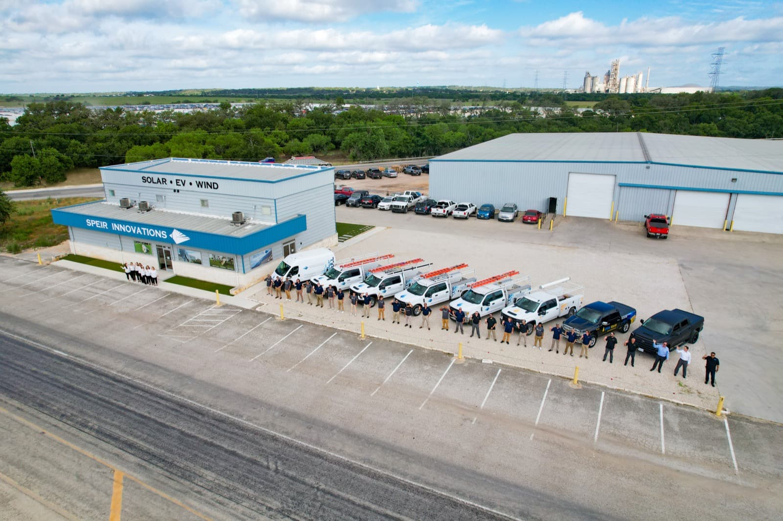 Company team beside a line of fleet trucks