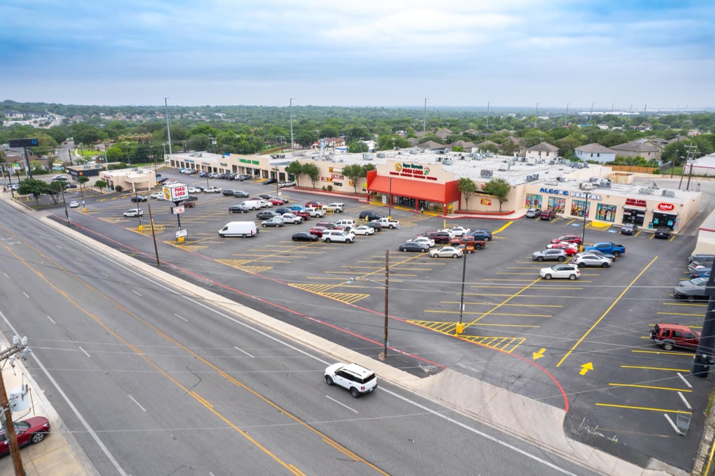 Retail center with its parking lot, driveways, and the road out front