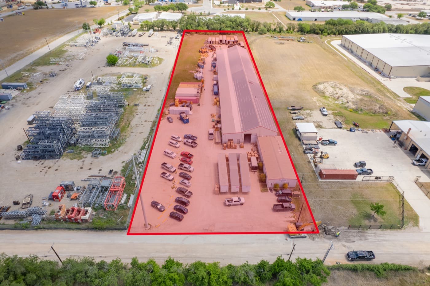 Aerial view of a parcel outlined in red within its surroundings