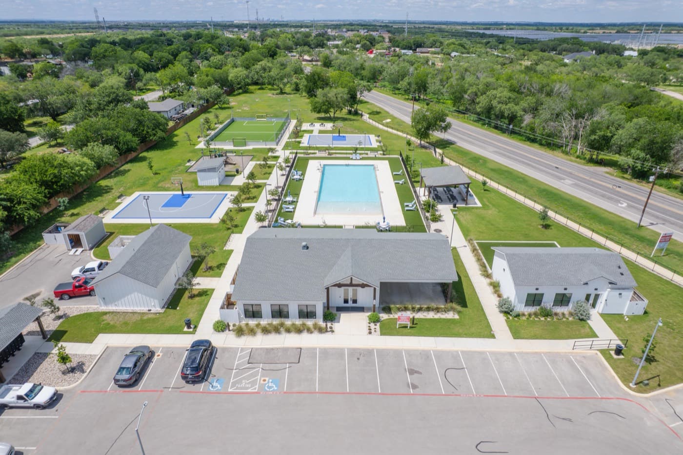 Aerial view of a residential community with a pool and clubhouse